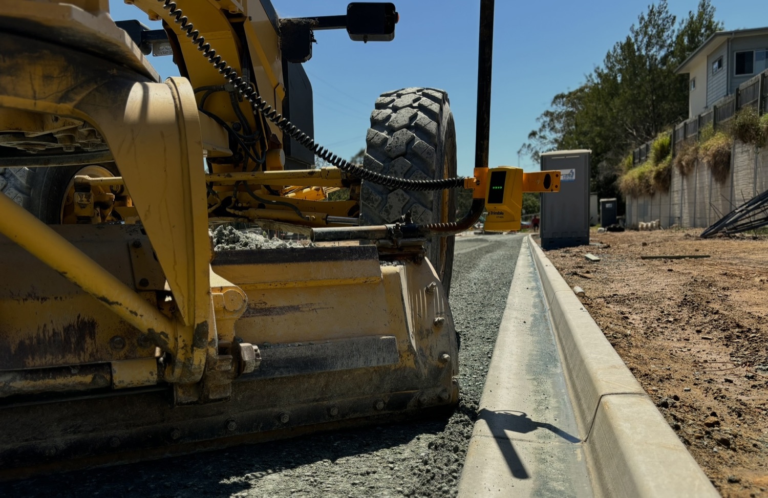 Final trim grading to kerb